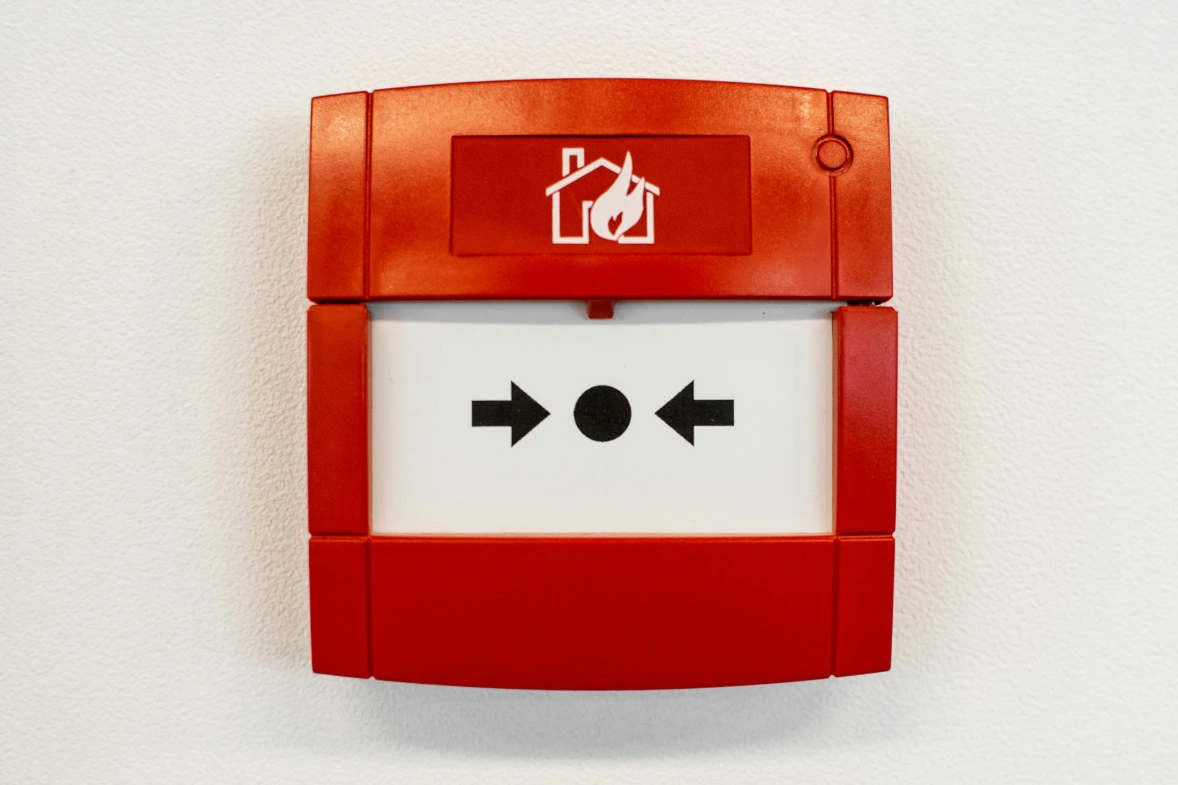 Manual fire alarm call point on a wall